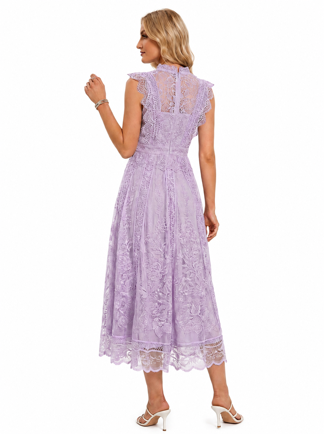 A woman modeling a lavender lace midi dress from the back, showing the high lace-up back, cap sleeves, and full skirt on a white background.