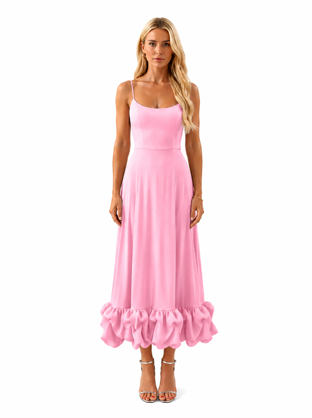 A woman modeling a light pink maxi dress with spaghetti straps, a fitted bodice, and a ruffled hem, standing against a plain white background.