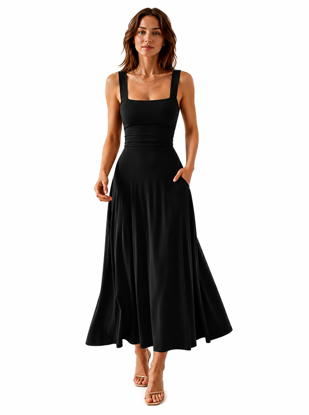 A woman modeling a black sleeveless maxi dress with a square neckline, wide shoulder straps, a fitted bodice, and a flowing skirt with side pockets, shown against a plain white background.